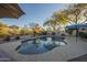 Beautiful backyard pool with a patio umbrella and desert plants offering a refreshing retreat and relaxing ambiance at 7149 E Quartz St, Mesa, AZ 85207