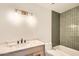 Stylish bathroom featuring a modern vanity, tub with tiled walls, and contemporary light fixture at 726 N 78Th St, Scottsdale, AZ 85257