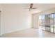 Bright bedroom features white walls, a ceiling fan, tile floors, and a sliding glass door at 726 N 78Th St, Scottsdale, AZ 85257