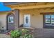 Inviting front entry featuring a decorative door, brick accents, and colorful landscaping at 726 N 78Th St, Scottsdale, AZ 85257