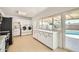 Well-lit kitchen with stainless steel appliances, white cabinets, and a view of the backyard pool at 726 N 78Th St, Scottsdale, AZ 85257