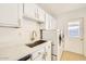 Well-organized laundry room with white cabinets, quartz countertop, stainless steel sink, and modern appliances at 726 N 78Th St, Scottsdale, AZ 85257