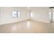 Bright, spacious living room with light tile flooring, a large window, and a white brick accent wall at 726 N 78Th St, Scottsdale, AZ 85257