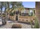 A building entrance with well-maintained landscaping, brick walls, and secure gate at Casa Feliz, offering a welcoming approach at 7401 E Northland Dr # 1, Scottsdale, AZ 85251