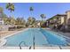 A refreshing community pool with lounge chairs, umbrellas, and palm trees, creating a resort-like atmosphere at 7401 E Northland Dr # 1, Scottsdale, AZ 85251