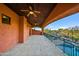 Covered outdoor patio area, with ceiling fans, offering views of desert landscaping at 7500 E Roy Rogers Rd, Scottsdale, AZ 85266