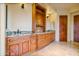 Bathroom featuring granite counters, double sinks, and custom wood cabinets at 7500 E Roy Rogers Rd, Scottsdale, AZ 85266