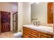 Bathroom features a walk-in glass shower, wood vanity and marble countertops at 7500 E Roy Rogers Rd, Scottsdale, AZ 85266