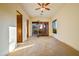 Spacious bedroom with double doors to patio, neutral carpet, and a ceiling fan at 7500 E Roy Rogers Rd, Scottsdale, AZ 85266