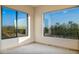 Bedroom view showcasing a scenic desert landscape through large windows at 7500 E Roy Rogers Rd, Scottsdale, AZ 85266