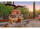 Stone fireplace with a majestic eagle statue, perfect for cozy outdoor gatherings at 7500 E Roy Rogers Rd, Scottsdale, AZ 85266