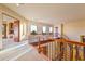 Elegant foyer with a curved staircase, wood railing, and view to lower level at 7500 E Roy Rogers Rd, Scottsdale, AZ 85266