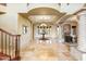 An elegant foyer with marble floors, a chandelier, and a stone fireplace at 7500 E Roy Rogers Rd, Scottsdale, AZ 85266