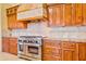 Close-up of kitchen range and granite countertops with custom cabinetry at 7500 E Roy Rogers Rd, Scottsdale, AZ 85266