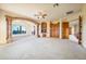 Spacious living room featuring a stone archway, fireplace, and scenic views at 7500 E Roy Rogers Rd, Scottsdale, AZ 85266