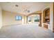 Expansive living area showcasing a stone archway, fireplace, and natural light at 7500 E Roy Rogers Rd, Scottsdale, AZ 85266