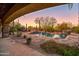 Beautiful backyard pool with waterfalls and desert landscaping at 7500 E Roy Rogers Rd, Scottsdale, AZ 85266