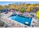 Aerial view of a luxurious pool with cascading waterfalls and a swim-up bar, surrounded by desert landscaping at 7500 E Roy Rogers Rd, Scottsdale, AZ 85266