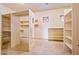 Spacious walk-in closet with built-in shelving and natural light at 7500 E Roy Rogers Rd, Scottsdale, AZ 85266