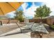 Spacious backyard with a hammock, shade umbrella and mature trees at 77 W Diamond Trl, San Tan Valley, AZ 85143