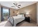 Comfortable bedroom with natural light, ceiling fan, and neutral color scheme at 77 W Diamond Trl, San Tan Valley, AZ 85143