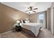 Well-lit bedroom with a large window, neutral decor, and a comfortable bed at 77 W Diamond Trl, San Tan Valley, AZ 85143