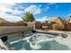 Relaxing hot tub in backyard oasis with desert landscaping at 77 W Diamond Trl, San Tan Valley, AZ 85143