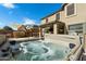 Inviting backyard hot tub with covered patio and desert landscaping at 77 W Diamond Trl, San Tan Valley, AZ 85143