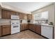 Functional kitchen with white appliances, wood cabinets, and ample counter space at 77 W Diamond Trl, San Tan Valley, AZ 85143