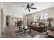 Open-concept living room with tile floors, a ceiling fan, and backyard access at 77 W Diamond Trl, San Tan Valley, AZ 85143