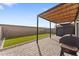 Outdoor space featuring stone pavers, artificial grass, a pergola, and storage shed at 781 W Flintlock Way, Chandler, AZ 85286