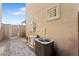 Home exterior featuring stone pavers, a gate, and air conditioning units at 781 W Flintlock Way, Chandler, AZ 85286