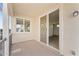 Neutral-toned covered balcony features sliding glass doors and a large window for natural light at 781 W Flintlock Way, Chandler, AZ 85286