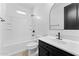 All-white bathroom featuring a shower-tub combo and a vanity with matte black hardware at 781 W Flintlock Way, Chandler, AZ 85286