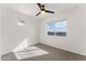 Bright bedroom featuring neutral carpet, fan, and window providing natural light at 781 W Flintlock Way, Chandler, AZ 85286