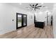 Finished bonus room featuring wood floors, a ceiling fan, and access to the backyard at 781 W Flintlock Way, Chandler, AZ 85286