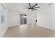 Bright living area featuring a fan, balcony access, neutral paint and tile flooring at 781 W Flintlock Way, Chandler, AZ 85286