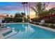 Inviting pool with mature landscaping and a serene sunset backdrop at 8336 E Calle De Alegria --, Scottsdale, AZ 85255