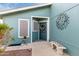 Home exterior featuring a tiled bench, artistic sun decoration, and a secure screen door at 8500 E Southern Ave # 488, Mesa, AZ 85209