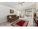 Bright living room featuring neutral carpet, contemporary ceiling fan, and sliding glass doors at 8500 E Southern Ave # 488, Mesa, AZ 85209