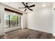 Bright bedroom showcasing hardwood floors and a large window overlooking the landscaped yard at 8502 E Cave Creek Rd # 53, Carefree, AZ 85377