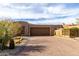 A large garage and gated entry with desert landscaping add curb appeal to this home at 8502 E Cave Creek Rd # 53, Carefree, AZ 85377