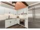 Modern kitchen featuring stainless steel appliances, white cabinets, and dark hardware at 8502 E Cave Creek Rd # 53, Carefree, AZ 85377