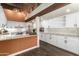 Bright kitchen with white cabinets, stone countertops, stainless steel appliances, and unique light fixtures at 8502 E Cave Creek Rd # 53, Carefree, AZ 85377