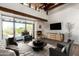 Comfortable living room featuring an inviting fireplace, a patio view, and contemporary furniture at 8502 E Cave Creek Rd # 53, Carefree, AZ 85377