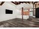 Spacious open-concept living space featuring hardwood floors, and a partial view of the kitchen at 8502 E Cave Creek Rd # 53, Carefree, AZ 85377
