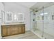 Elegant bathroom with double sinks, granite countertops, and a frameless glass shower with decorative tile at 8630 W Apache St, Tolleson, AZ 85353