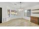 Inviting dining area boasting natural light, a stylish light fixture, and modern floating shelves at 8630 W Apache St, Tolleson, AZ 85353