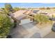 Aerial view of a single Gathering home showcasing the driveway, garage, and solar panels at 8630 W Apache St, Tolleson, AZ 85353