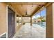 Covered patio featuring a ceiling fan, overhead lighting, and tiled floor overlooking backyard and pool at 8630 W Apache St, Tolleson, AZ 85353